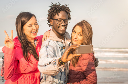 group of multiracial people taking a selfie photo