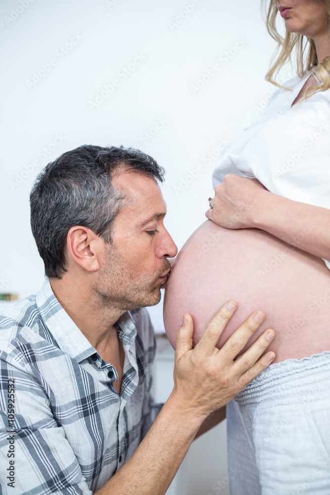 Man kissing the belly of pregnant woman Man kissing the belly of pregnant woman