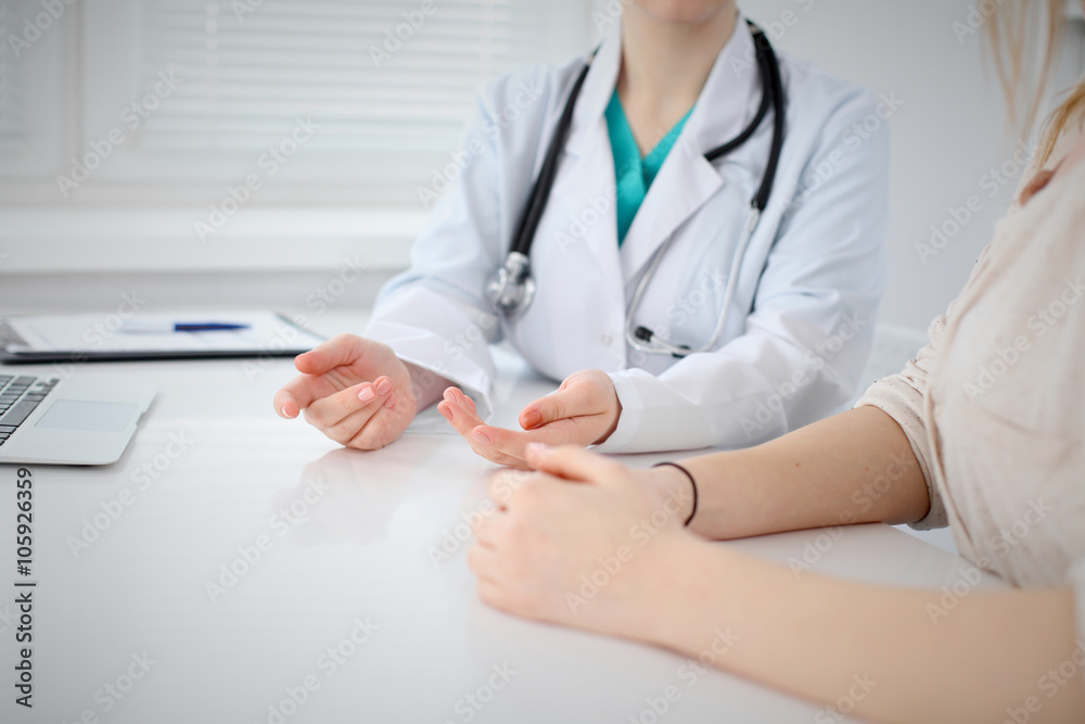 Doctor and patient are discussing something, just hands at the table Doctor and patient are discussing something, just hands at the table