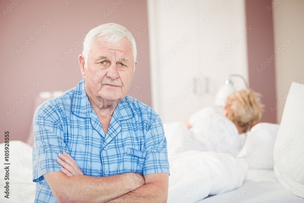 Portrait of senior man sitting at home