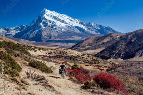 Traveler on mountain bike cycling trail in mountains