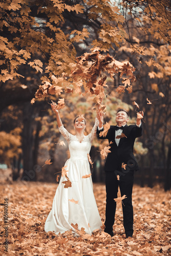 Luxury married wedding couple, bride and groom posing in park autumn