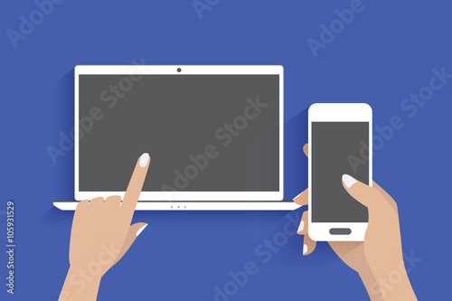 Modern laptop and hand using a smartphone, Blue background.