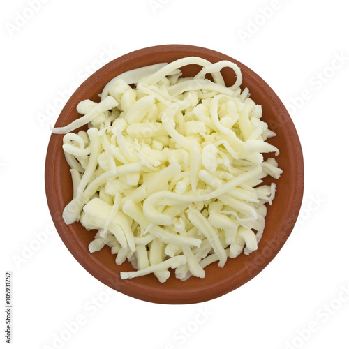 Pizza cheese in a small bowl isolated on a white background top view.
