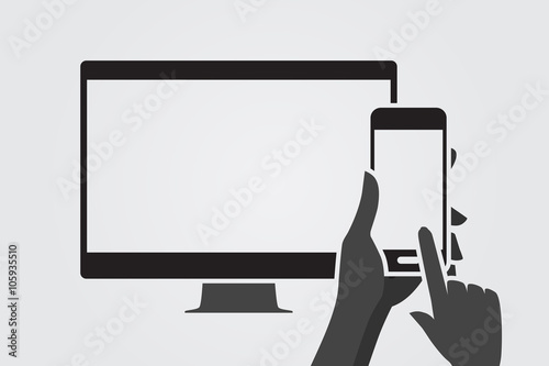 Modern computer screen and hand using smartphone.