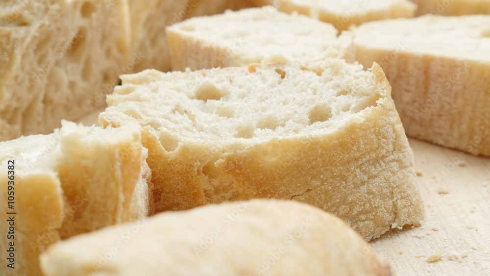 French bread baguette on the table close-up 4K 2160p UltraHD slow tilt footage - French traditional bread baguette on chopping board 4K 3840X2160 UHD video French bread baguette on the table close-up 4K 2160p UltraHD slow tilt footage - French traditional bread baguette on chopping board 4K 3840X2160 UHD video