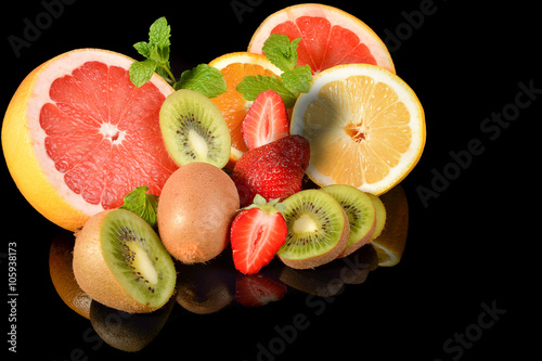 strawberries  grapefruit  lemon  kiwi and oranges isolated on a black background with reflectionson 