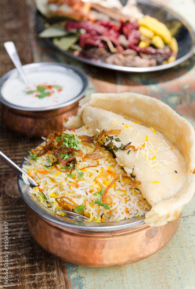 Authentic chicken biryani served with naan bread, fragrant pilau rice