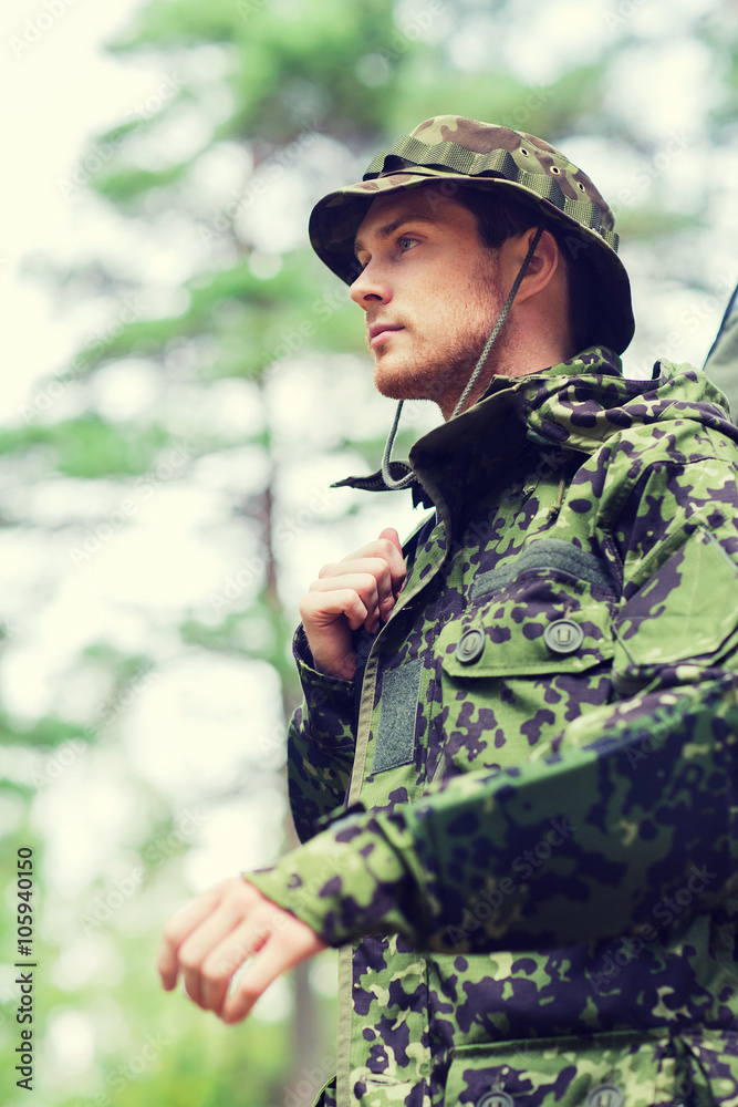 young soldier or hunter with gun in forest young soldier or hunter with gun in forest