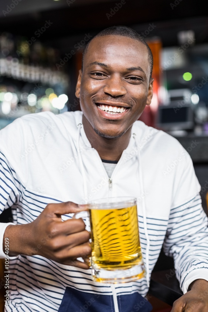 Portrait of smiling man drinking a beer