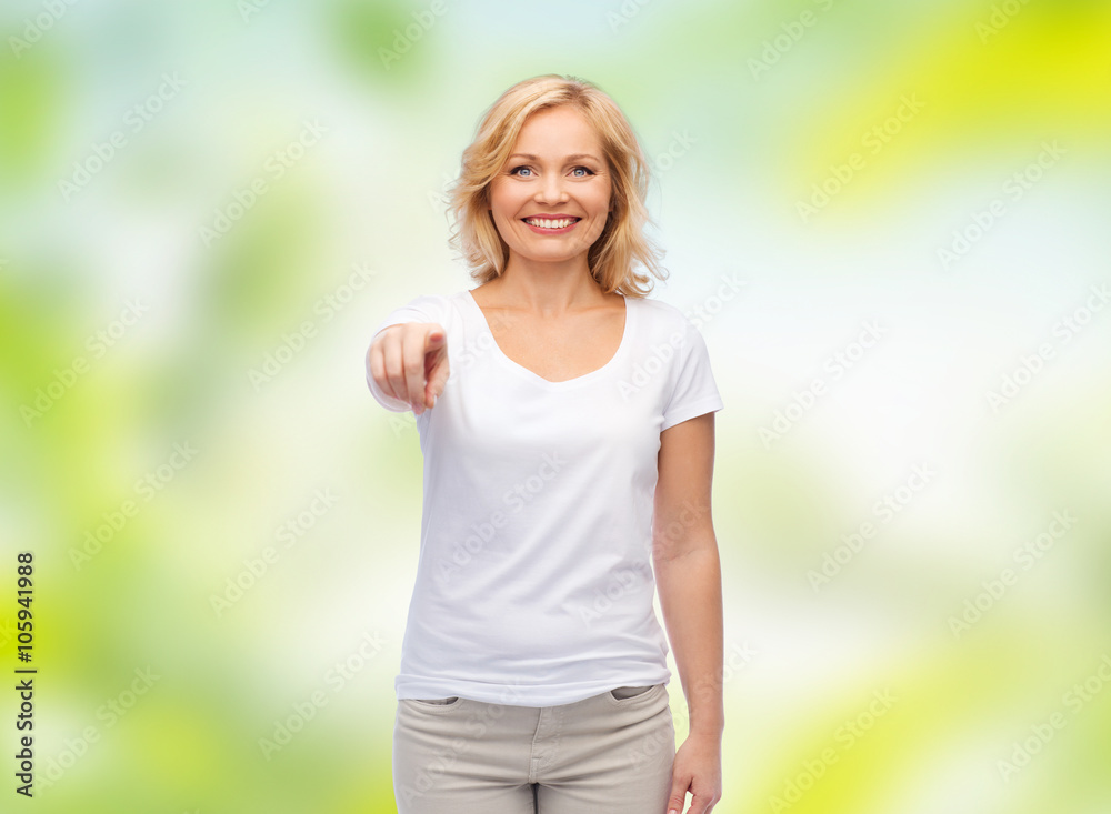smiling woman in white t-shirt pointing to you smiling woman in white t-shirt pointing to you