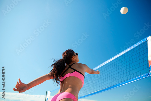 Photography young woman with ball playing volleyball on beach