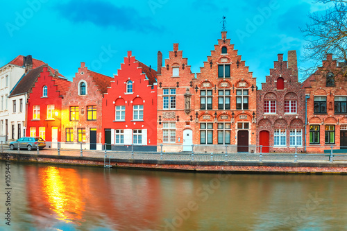 Scenic city view of Bruges canal with beautiful medieval colored houses and reflections, Belgium