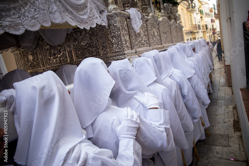 costaleros procesionando por las calles de málaga photo