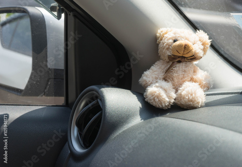 car air conditioner grid panel on console and teddy bear