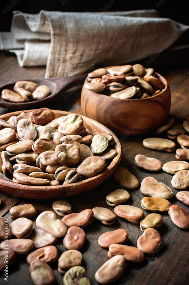 Fava beans in wooden bowls. Rustic style. Toned image. Selective focus