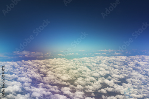 View of the colour sky and clouds from the airplane porthole