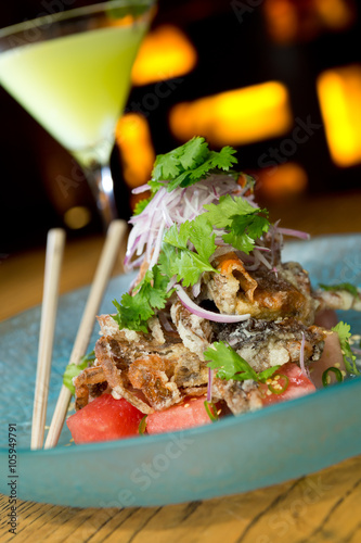 king crab tempura, served with red onion, watermelon, garnish and finished off with a drizzle of tangy amazu ponzu sauce photo