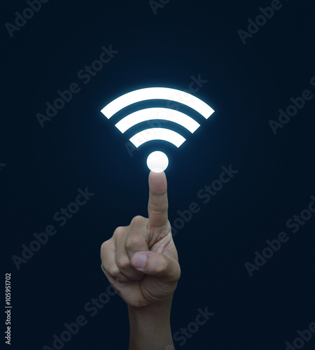 Hand pressing wi-fi button over blue background, Technology and