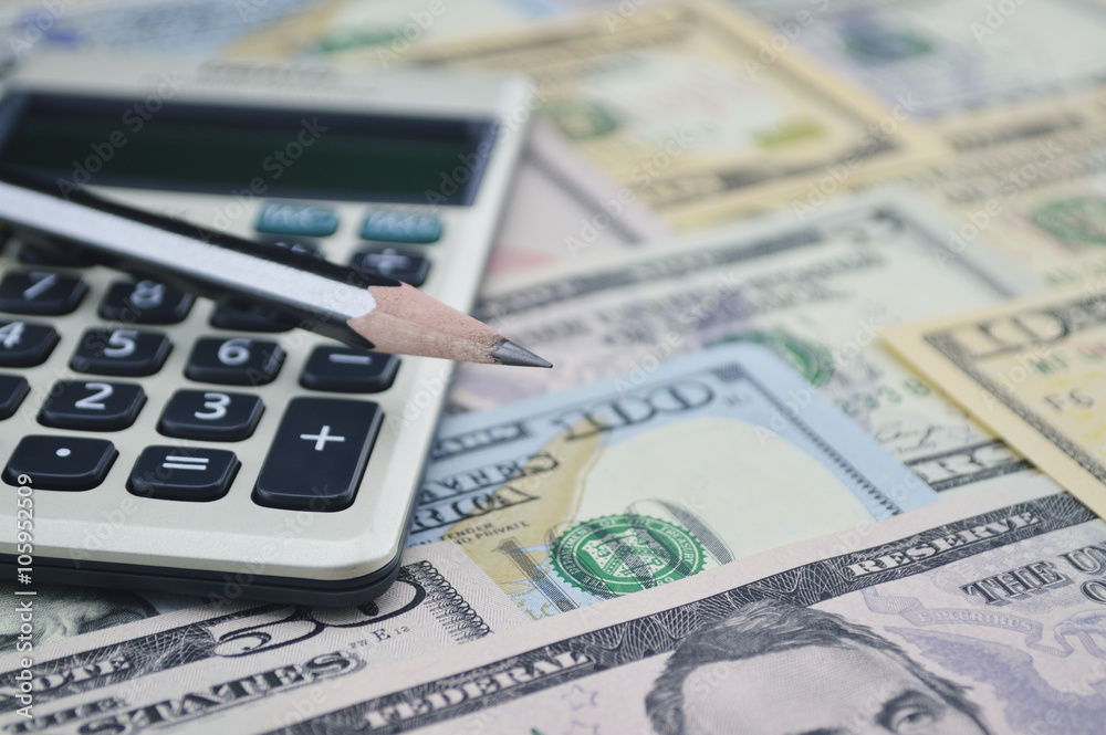 Pencil and calculator on dollar bank note money, Finance concept Pencil and calculator on dollar bank note money, Finance concept