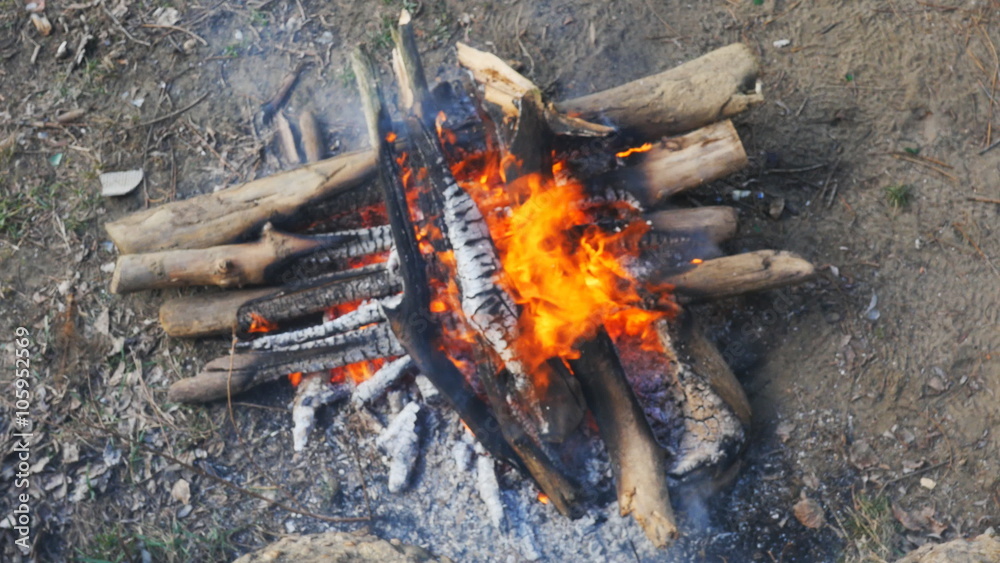 firewood, stacked crosswise fire burning in the fire outdoors firewood, stacked crosswise fire burning in the fire outdoors