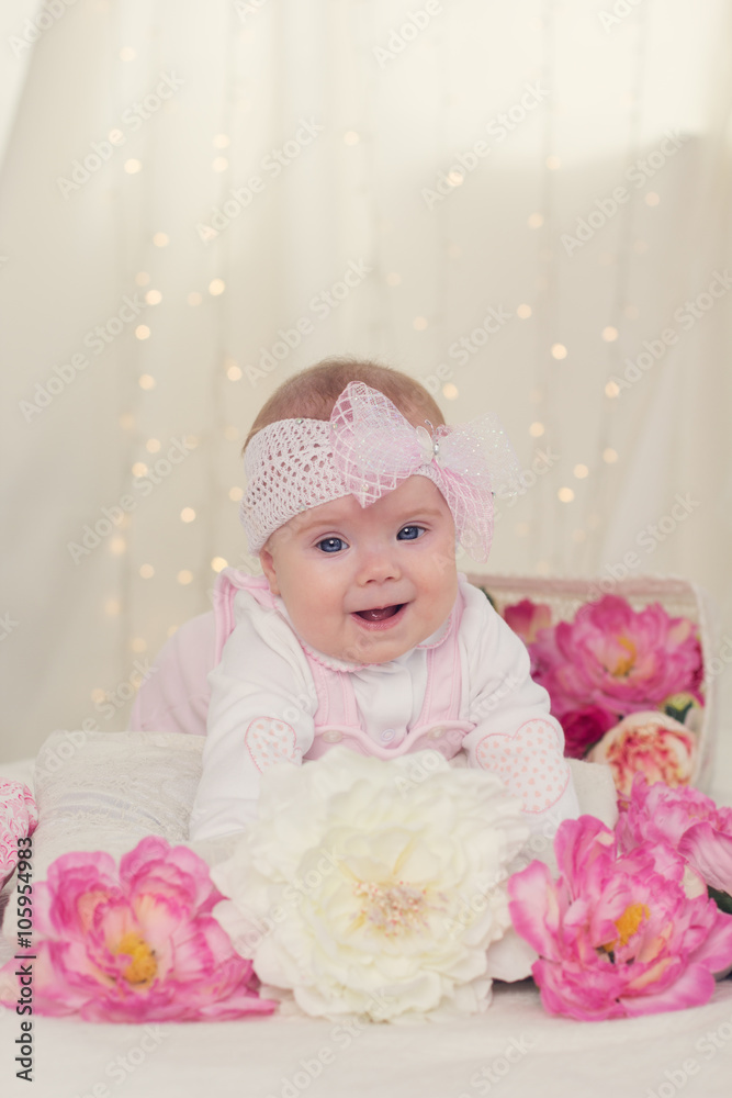 Baby girl in bed with pink flowers Baby girl in bed with pink flowers