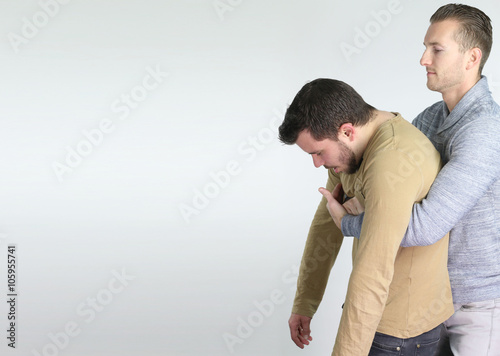first aid gesture for someone who is choking photo