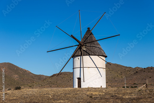 Traditional white windmill in Pozo de los Frailes. Natural Park of Cabo de Gata. Spain.