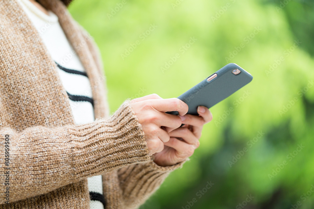 Woman use of mobile phone over green background