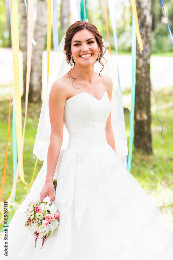 Beautiful bride outdoors in a forest. Beautiful bride outdoors in a forest.
