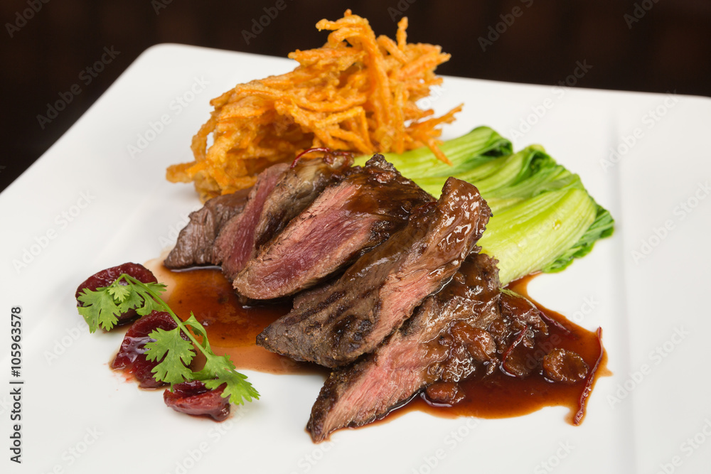 Flame grilled ,rare kangaroo steak loin, served with pak choi and a red  wine sauce Stock-Foto | Adobe Stock