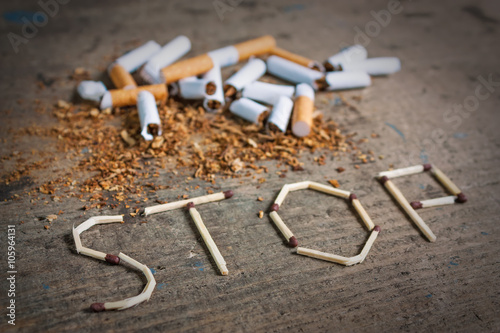 Stop smoking background with broken cigarettes photo