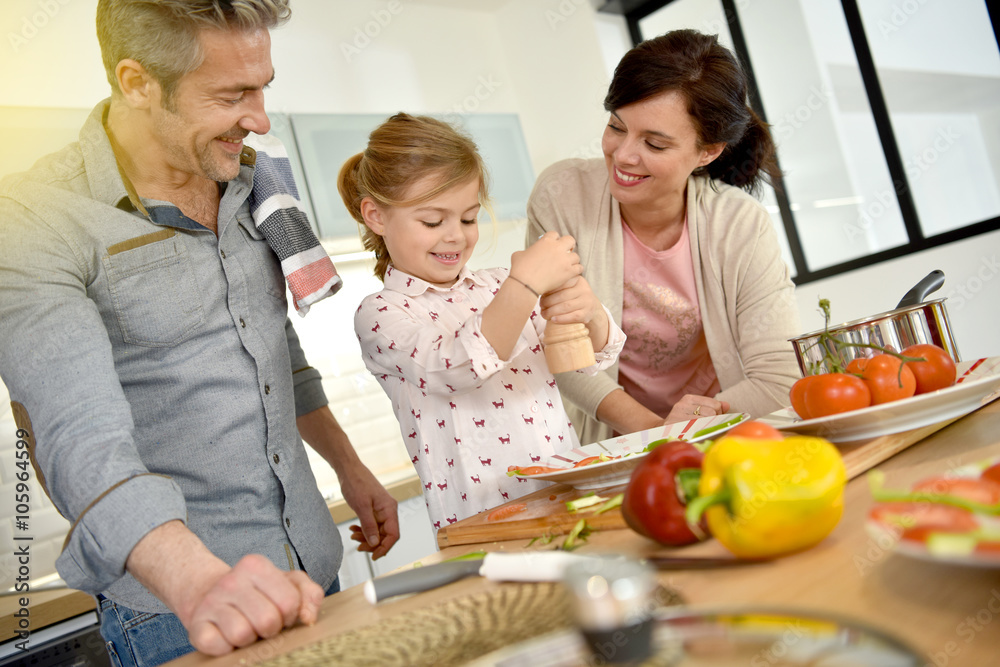 Parents with child cooking together at home Parents with child cooking together at home