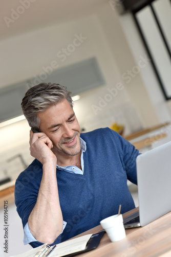 Man working from home-office with laptop computer photo