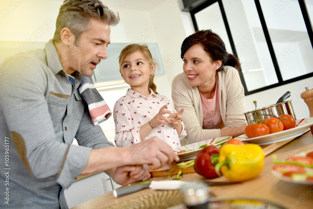 Parents with child cooking together at home Parents with child cooking together at home