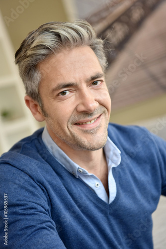 Portrait of smiling handsome man with grey hair