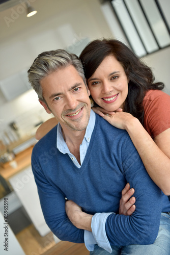 Portrait of middle-aged couple enjoying new home