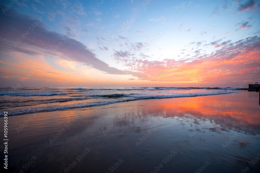 Beach with glossy surface reflecting beautiful seascape on the sunset in Maspalomas on Gran Canaria island