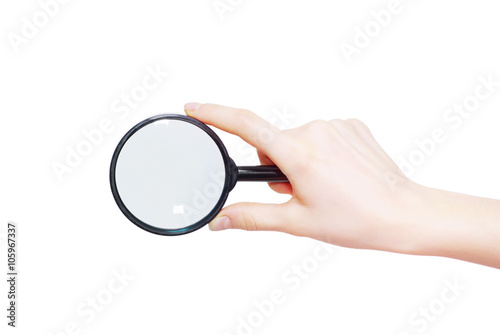 Man's hand holding magnifying glass