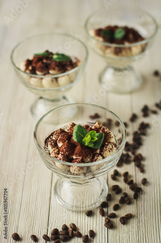 Tiramisu dessert in a glass with mint