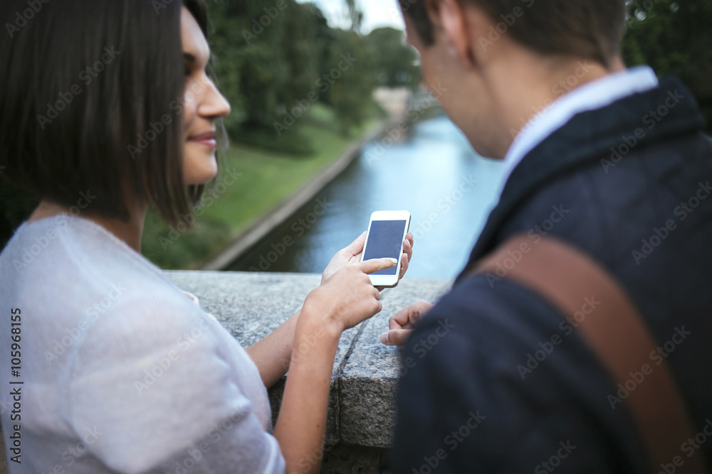 woman showing something to friend on her phone woman showing something to friend on her phone
