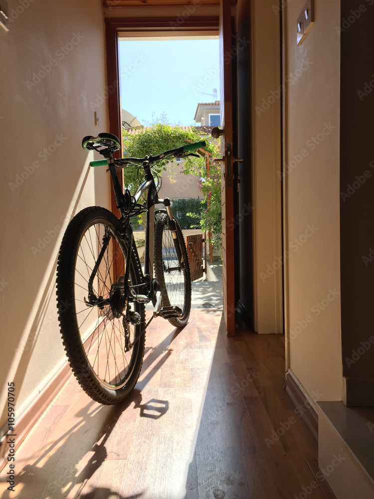 Bicycle indoor home at open door entrance Bicycle indoor home at open door entrance