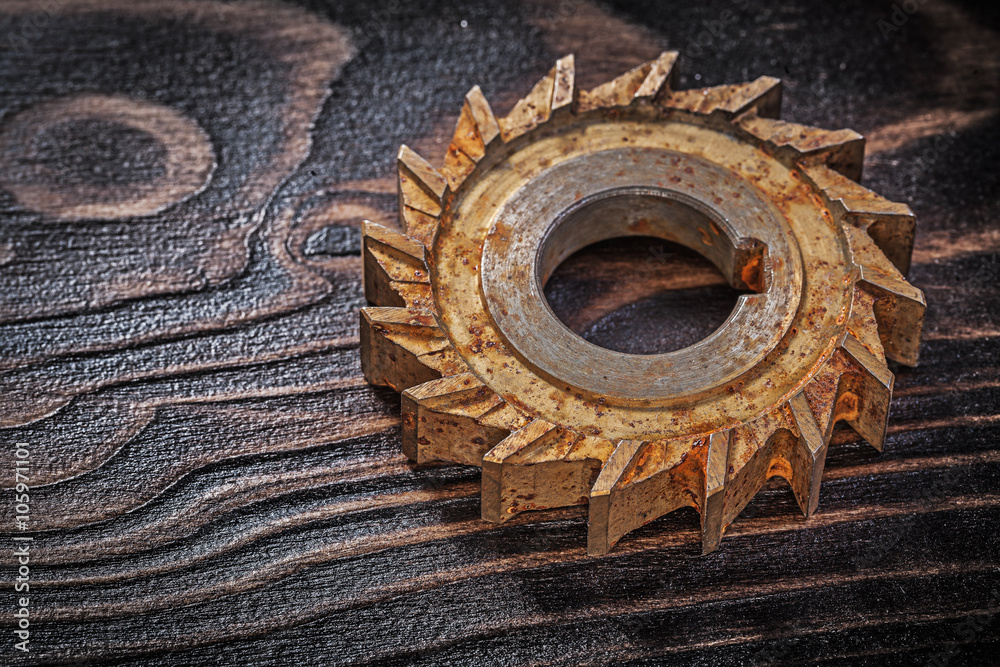 Rusted rotary cutter on vintage wood background construction con