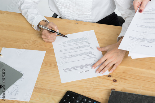 woman thinking about signing a contract