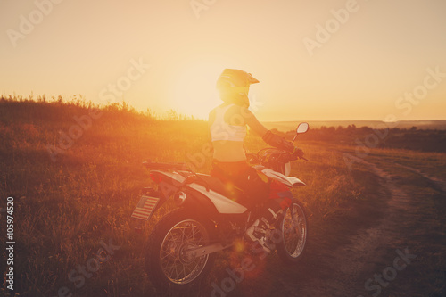 Woman biker in sunset, female motorcycle.