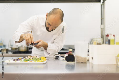 Male professional chef cooking in a kitchen.