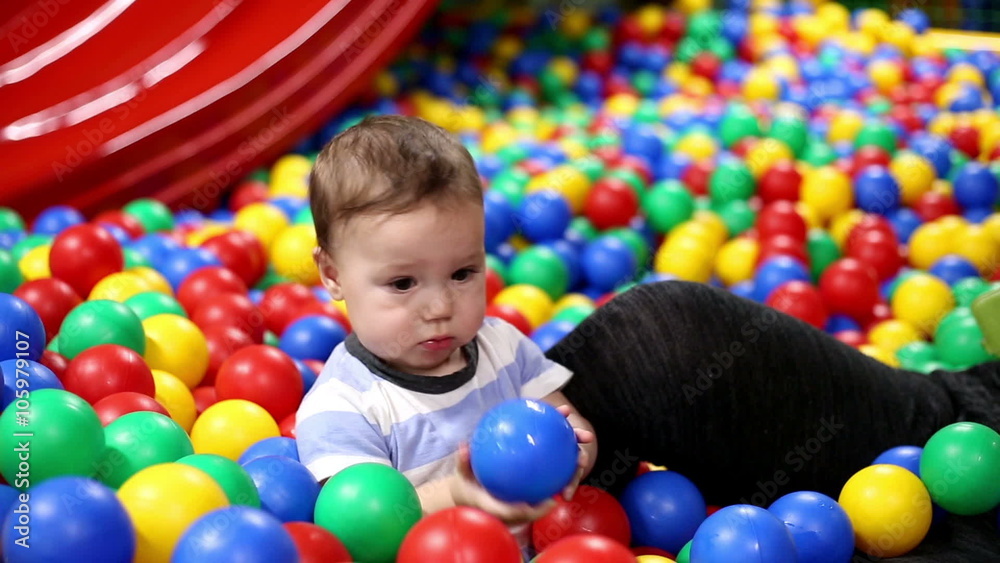 Baby play with balls in playground
Baby play with balls in playground