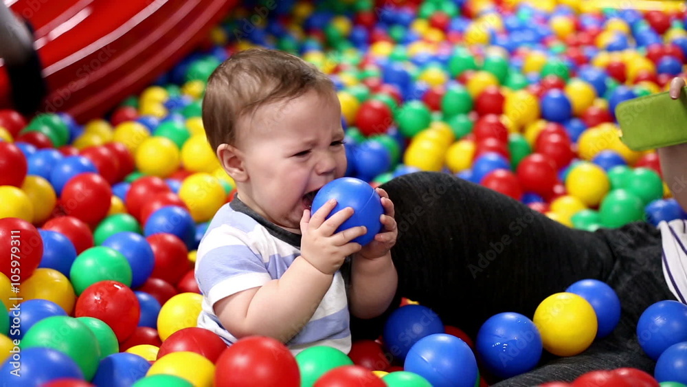Baby play balls with mother in playground
Baby play balls with mother in playground