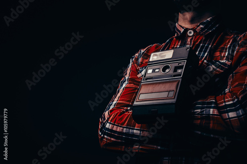 Retro instant camera around hipster photographers neck