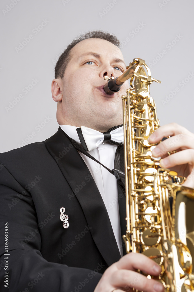 Fototapeta premium Music Themes and Ideas. One Caucasian Male Saxophonist Playing Saxophone